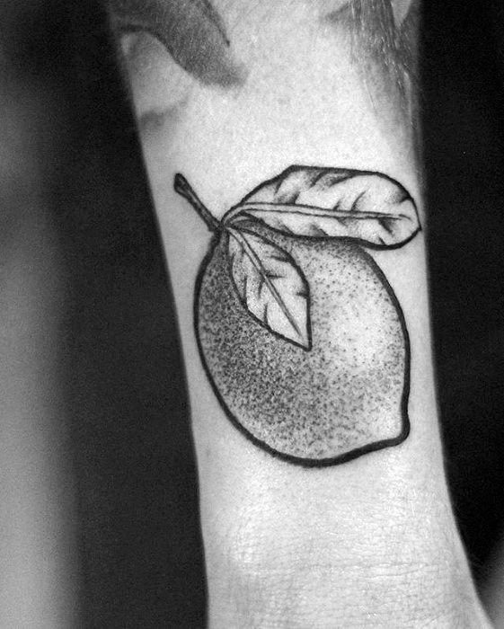 Black and grey tattoo of a single lemon with two leaves, detailed using soft dotwork shading and bold outlines.