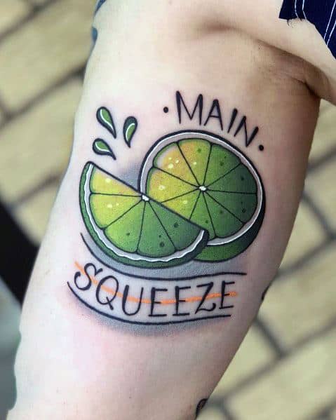 Playful lime wedge tattoo with "Main Squeeze" text, vibrant green shading, and juice droplets, creating a fun and refreshing design.