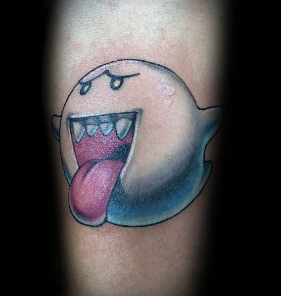 Mario ghost tattoo featuring Boo with a playful expression, sticking out its tongue, shaded in blue and black, inked on the arm.