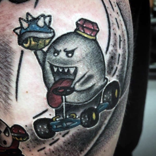 Mario ghost tattoo featuring Boo in a go-kart, holding a spiked blue shell with a mischievous grin, detailed shading, and dynamic motion lines.