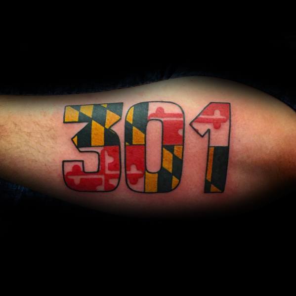 Bold "301" tattoo on the bicep filled with the Maryland flag pattern, representing pride in the state's area code with vibrant colors.