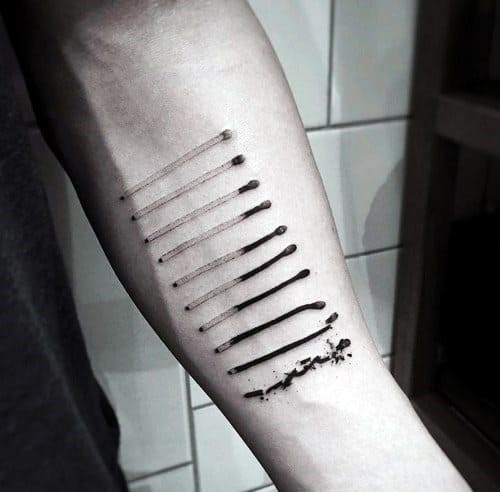 Progressive matchstick tattoo on forearm showing stages from unused to burnt out, symbolizing burnout, time, or transformation.