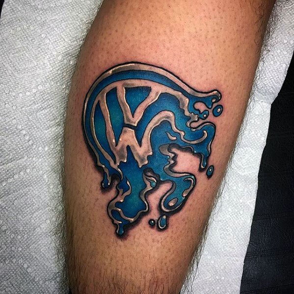 Blue melting Volkswagen logo tattoo on the leg with bold outlines and a dripping paint effect.