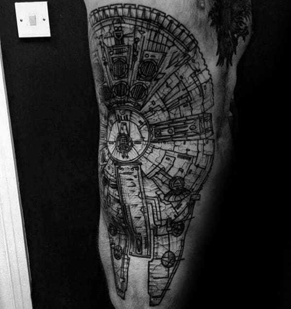 Large black linework Millennium Falcon tattoo covering the upper thigh with intricate technical detailing in a blueprint style.