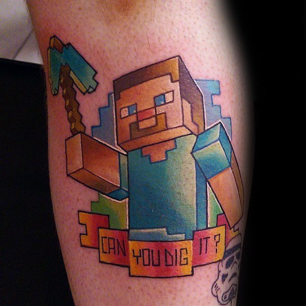 Colorful Minecraft Steve tattoo with a diamond pickaxe and a banner reading “CAN YOU DIG IT?” in pixelated style on the leg.