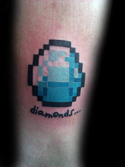 Pixelated Minecraft diamond tattoo with shaded blue tones and the word “diamonds...” written below in a playful handwritten font.