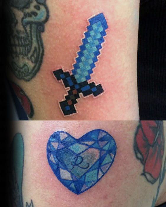 Top tattoo shows a pixelated Minecraft diamond sword in blue and black; bottom features a blue heart-shaped diamond with an “L” inside.