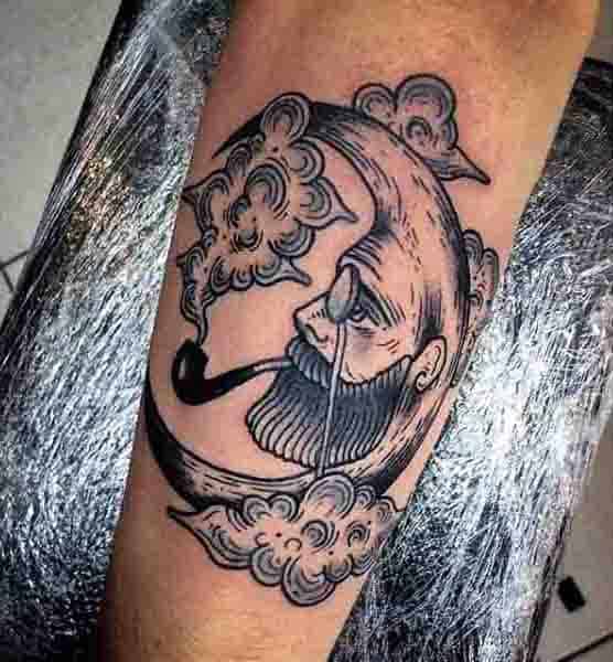 Guys Moon Face Tattoo With Smoking Pipe Design On Arm