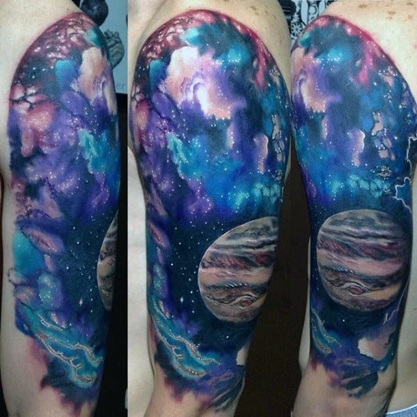 Colorful nebula tattoo with Jupiter and stars on an upper arm