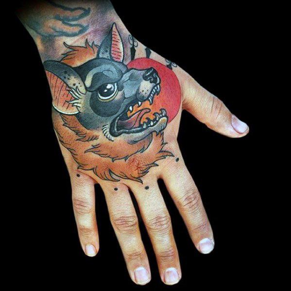 Neo-traditional bat tattoo on the hand with orange fur, sharp teeth, and a bold red circle background for dramatic contrast.