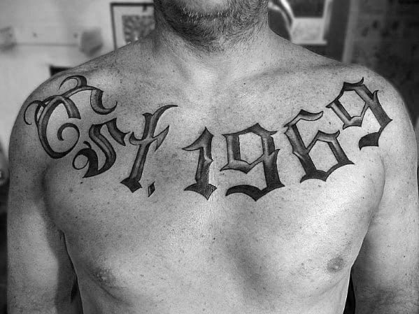 Guys Old Font Est 1969 Tattoo On Upper Chest