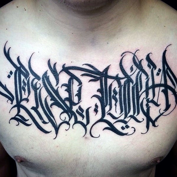 Guys Ornate Script Black Ink Tattoo On Upper Chest