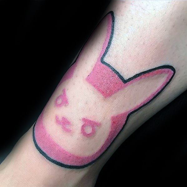 Minimalist pink tattoo of D.Va’s bunny logo from Overwatch, outlined in black and inked on the forearm.