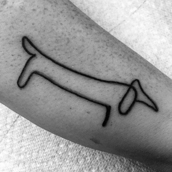 Minimalist tattoo of Picasso’s dachshund drawing, using a single bold line to form the playful and iconic outline of the dog.