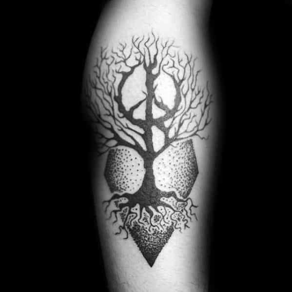 Black ink geometric tree tattoo on the leg, featuring a detailed tree with roots, a peace symbol in the branches, and abstract polygonal shapes.