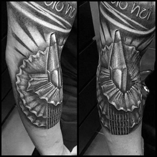 A masterful black and gray tattoo featuring a finely detailed pencil alongside its sharpener graces the forearm, enhanced with intricate shading effects