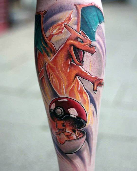 Epic Charizard and Charmander tattoo with fiery effects emerging from a Pokeball, blending evolution and flames in a dynamic forearm piece.