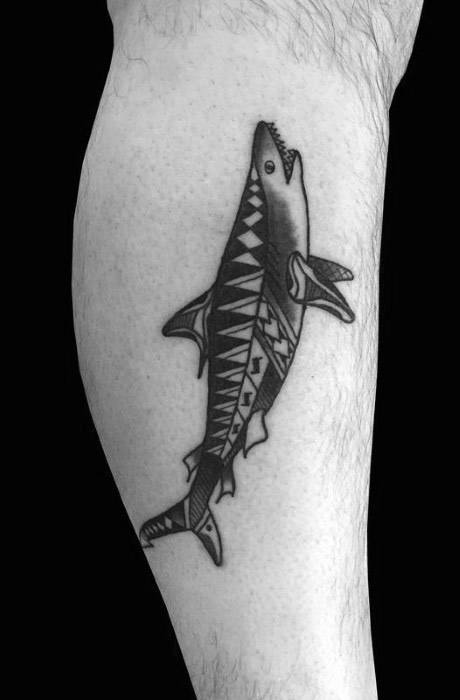 Polynesian shark tattoo on calf with sharp triangular patterns symbolizing adaptability, strength, and protection from ocean dangers.