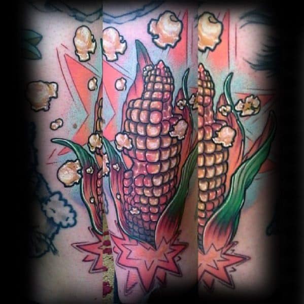 Colorful tattoo of corn cobs bursting into popcorn with star-shaped explosions and scattered kernels surrounding the vibrant design.