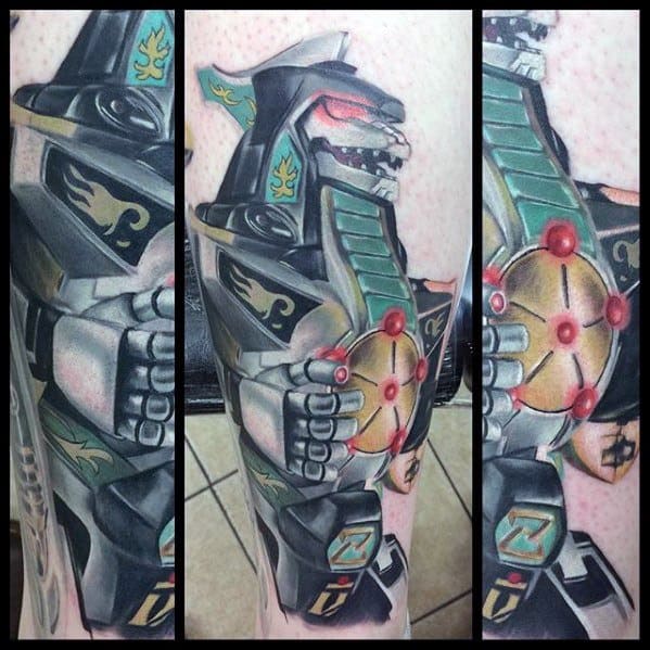Highly detailed tattoo of the Dragonzord in battle-ready stance, featuring metallic shading, red accents, and dynamic depth on the leg.