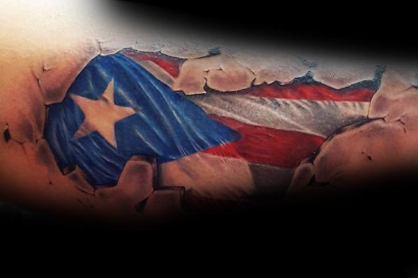 Puerto Rican flag tattoo with a cracked stone effect, revealing bold red, white, and blue colors with a striking star design underneath.
