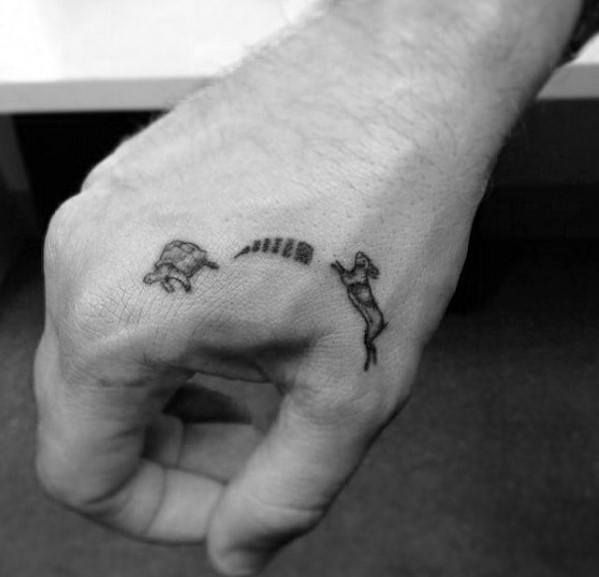 Guys Quarter Sized Turtle And Rabbit Speed Hand Tattoo Design Ideas
