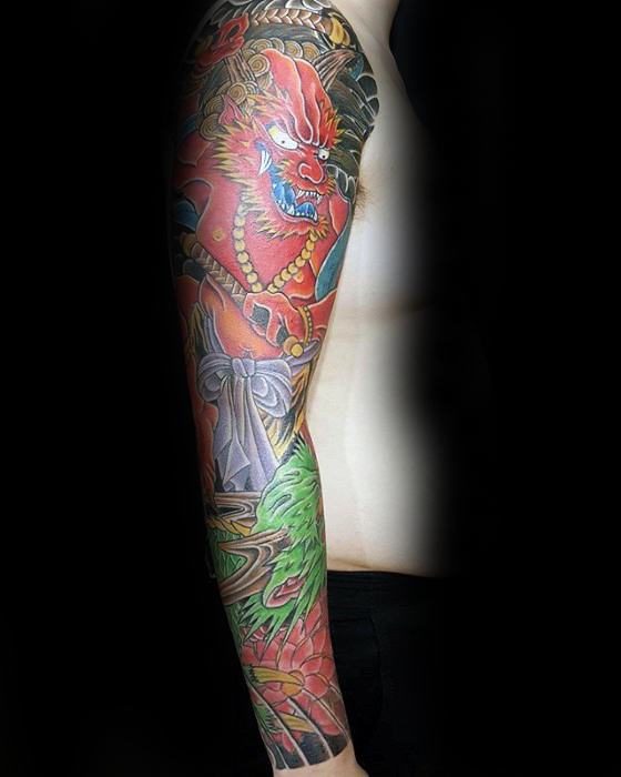 Colorful Raijin full sleeve tattoo with red thunder god, golden beads, green dragon, and traditional Japanese wave patterns.