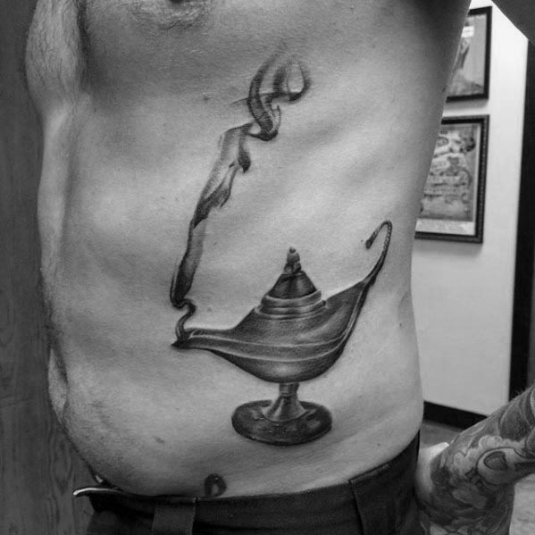 Genie lamp inked with smoke in black and white on a person's side