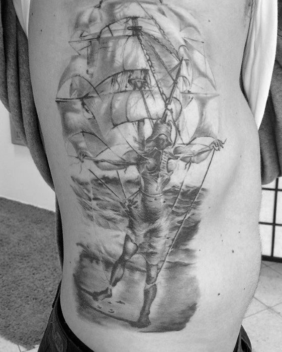 Large black and grey side tattoo inspired by Salvador Dali, blending a human figure with ship sails in a surreal, dreamlike composition.