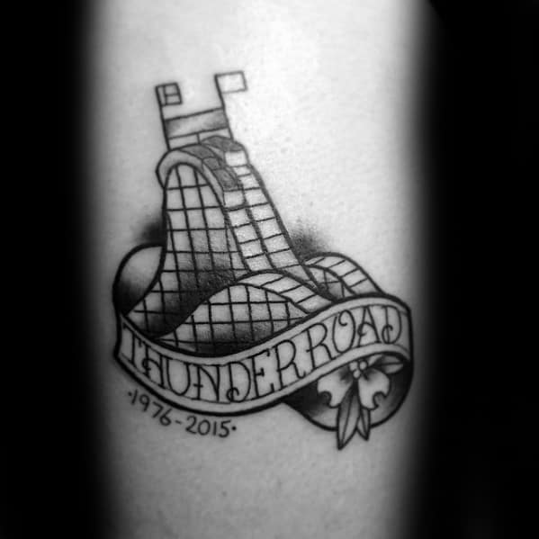 Memorial roller coaster tattoo with bold THUNDER ROAD banner, floral detail, and dates 1976–2015 honoring a retired ride.