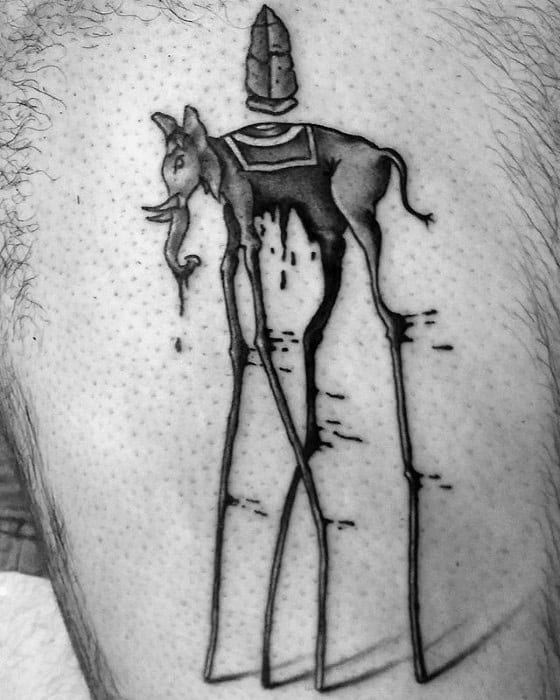 Black ink Salvador Dali-style tattoo of a surreal elephant with thin, elongated legs and an obelisk on its back, dripping with distortion.