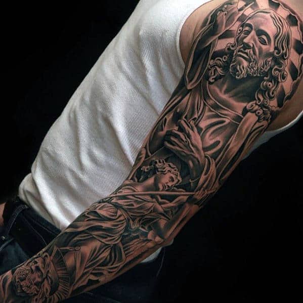 Sleeve tattoo featuring religious imagery on a person's arm