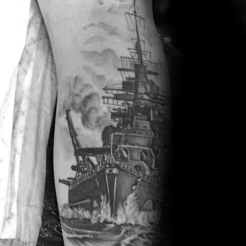 Forearm tattoo of a detailed battleship in striking black and gray