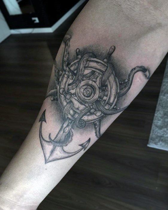 Forearm tattoo of an octopus intertwined with a ship's wheel and a detailed anchor