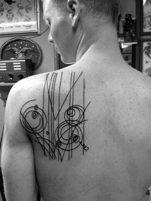Minimalist tattoo featuring abstract lines and swirling circles, creating a modern and artistic design with clean, sharp contrasts in black ink.