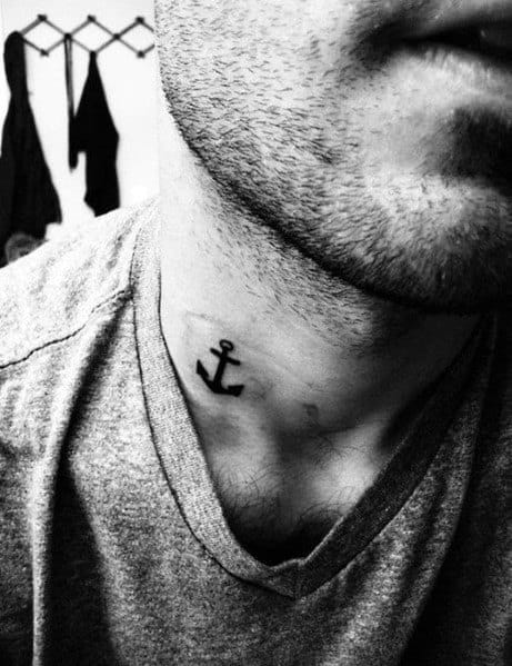 Small black anchor tattoo on the neck, featuring a simple and bold design, symbolizing stability, strength, and a deep connection to the sea.