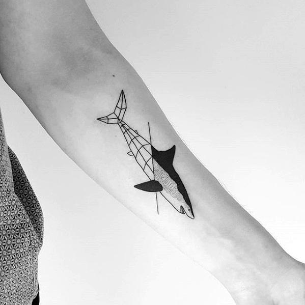 Geometric whale tattoo on the inner forearm with abstract line design