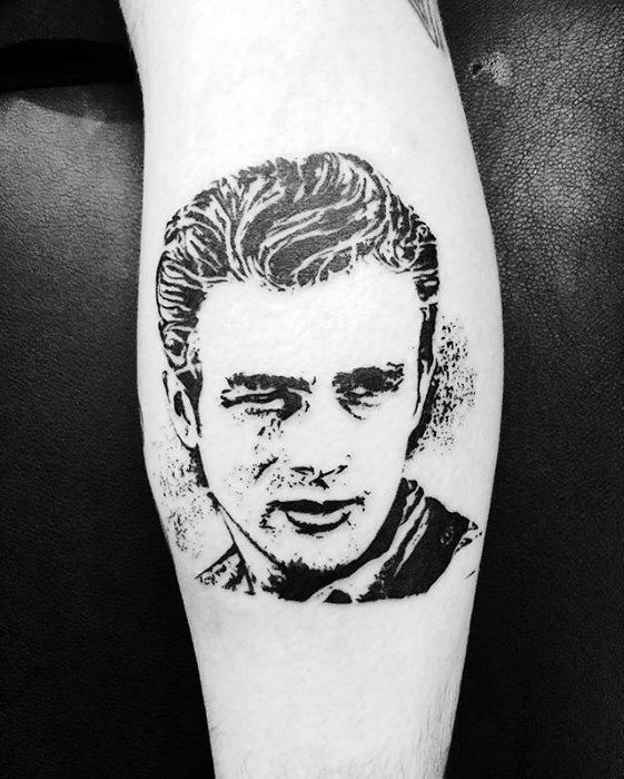 Black ink stencil-style tattoo of James Dean's portrait with bold lines and a classic expression on his face.
