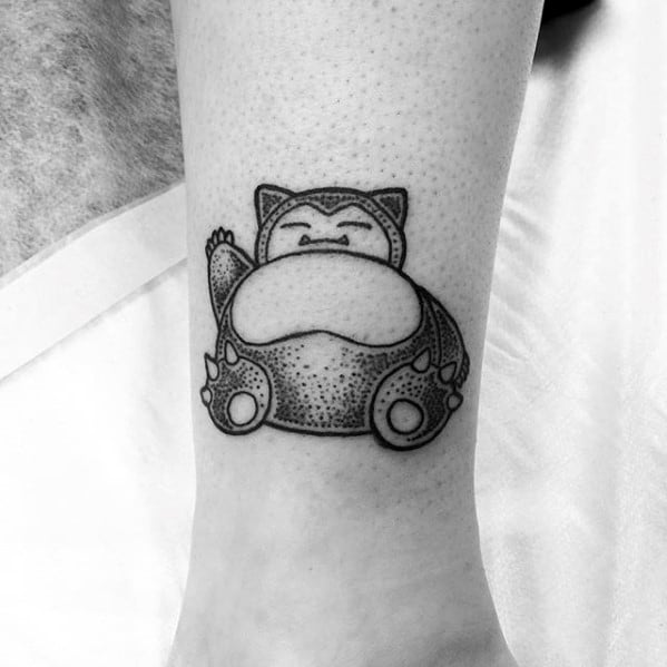 Blackwork Snorlax tattoo on lower leg with bold outlines and dot shading, showcasing a calm seated pose.