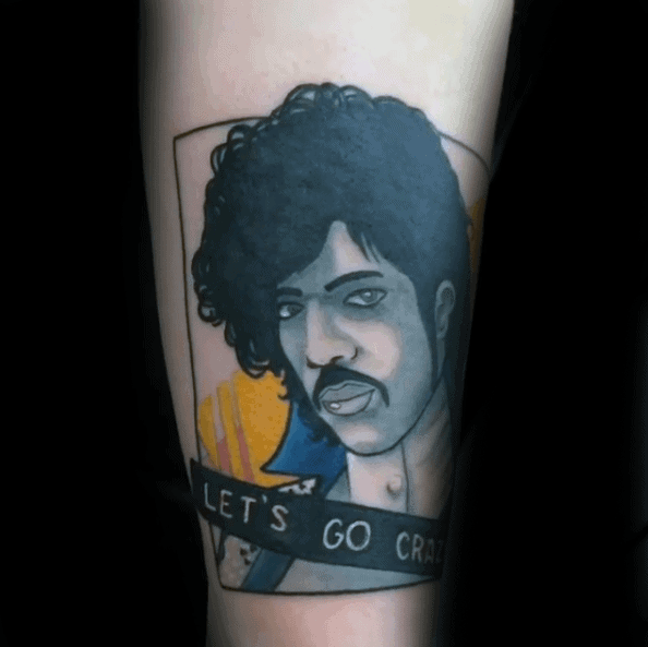 A colorful tattoo of Prince with the text "Let's Go Crazy," celebrating his iconic song and vibrant persona