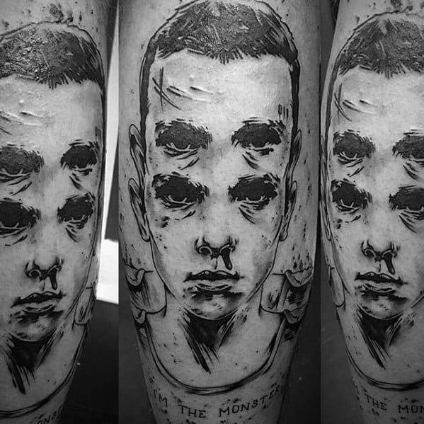 Blackwork tattoo of Eleven from Stranger Things with a distorted, glitch-style face and the words "I'm the monster" below.
