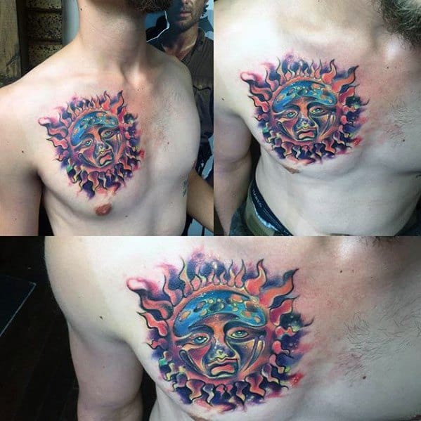 Chest tattoo of the Sublime sun face with bold blue, red, and purple flames, creating a vibrant, fiery focal point.