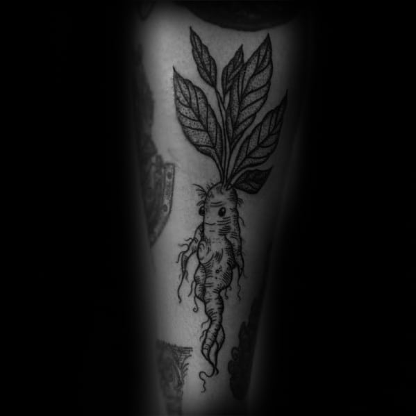 Black ink carrot tattoo with a twisted root and detailed leafy top, blending botanical and whimsical elements for a unique design.