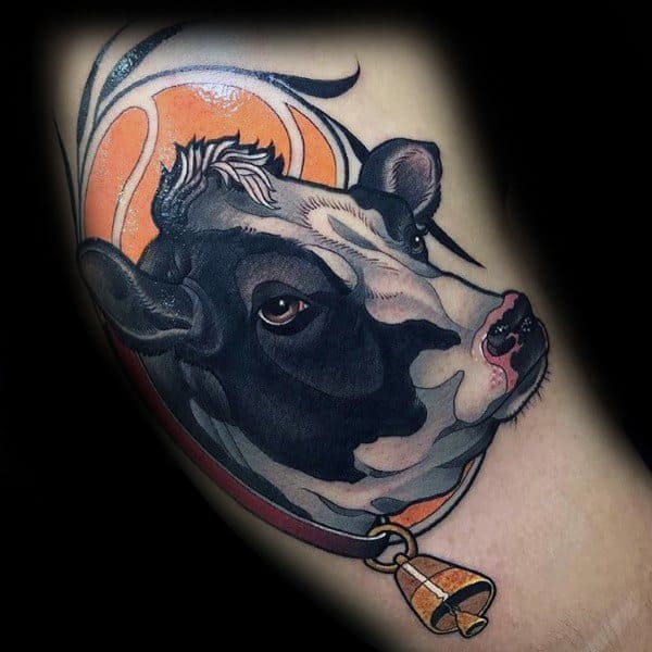 Realistic cow head tattoo with bold outlines, warm orange background, red collar, and a detailed bell hanging below the chin.