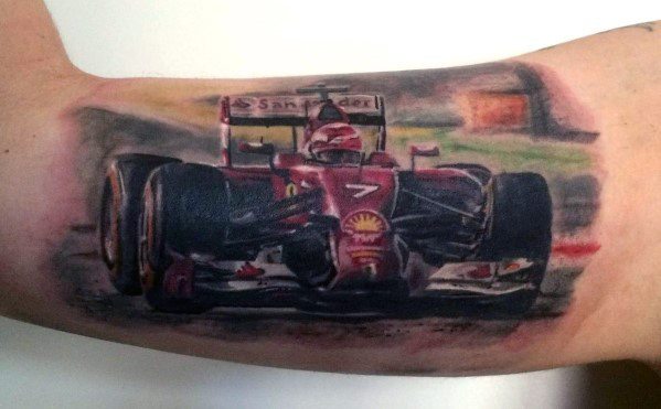 Detailed Ferrari Formula 1 race car tattoo in action on man's arm, highlighting speed, precision, and racing passion.