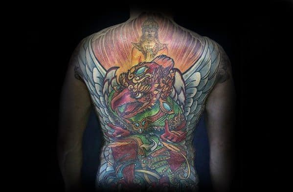Full back Garuda tattoo in vivid colors, depicting a majestic winged figure with glowing background and detailed ornamental armor.