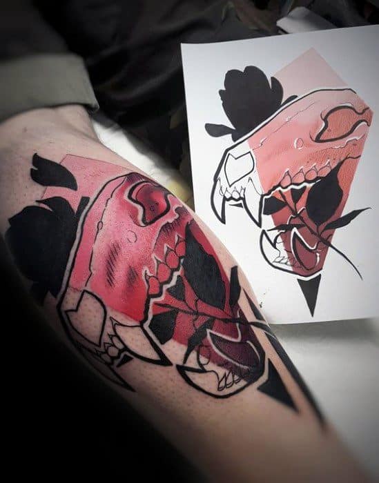 Abstract tattoo of a dinosaur skull with bold black shapes and a pink gradient fill, blending realism with geometric and floral elements.