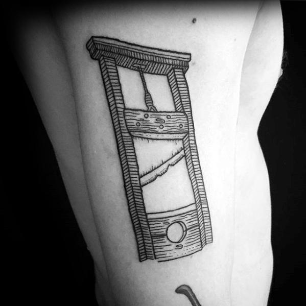 Minimalist guillotine tattoo with clean black linework, subtle wood grain details, and a slightly tilted perspective for a bold look.