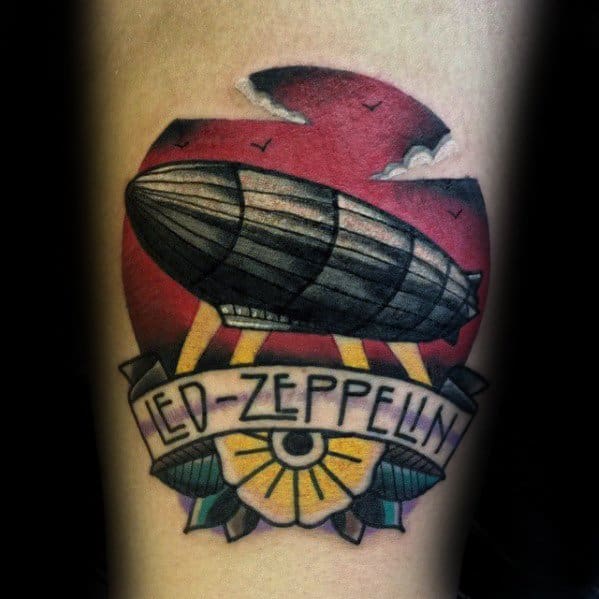 Traditional-style color tattoo of a Zeppelin airship flying over a sunset with a floral banner reading Led Zeppelin.