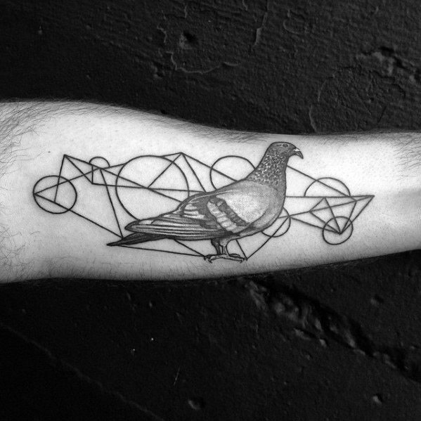 Realistic pigeon tattoo on forearm with abstract geometric background, merging nature with modern design elements in black ink.
